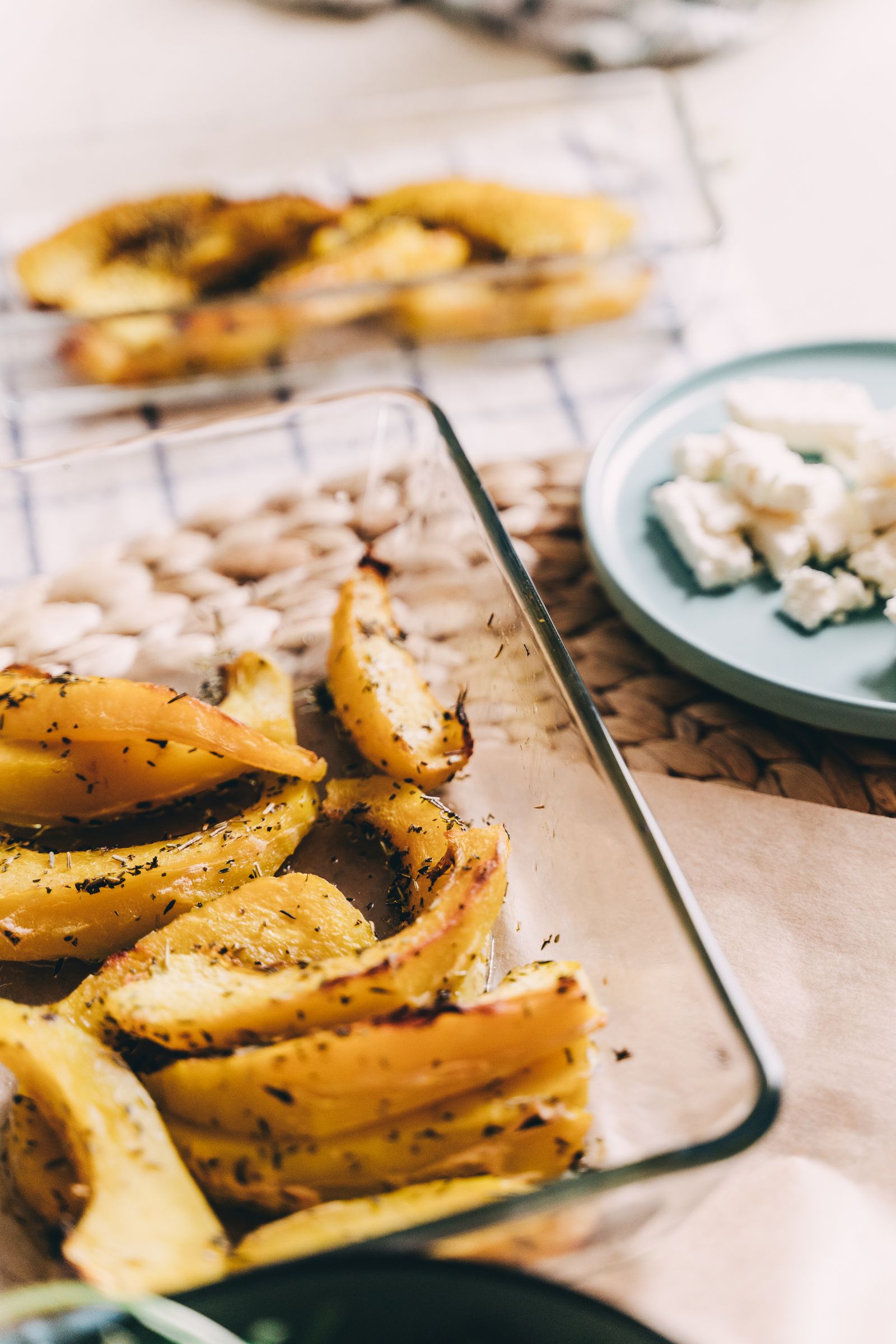 Roasted squash wedges in a glass baking dish